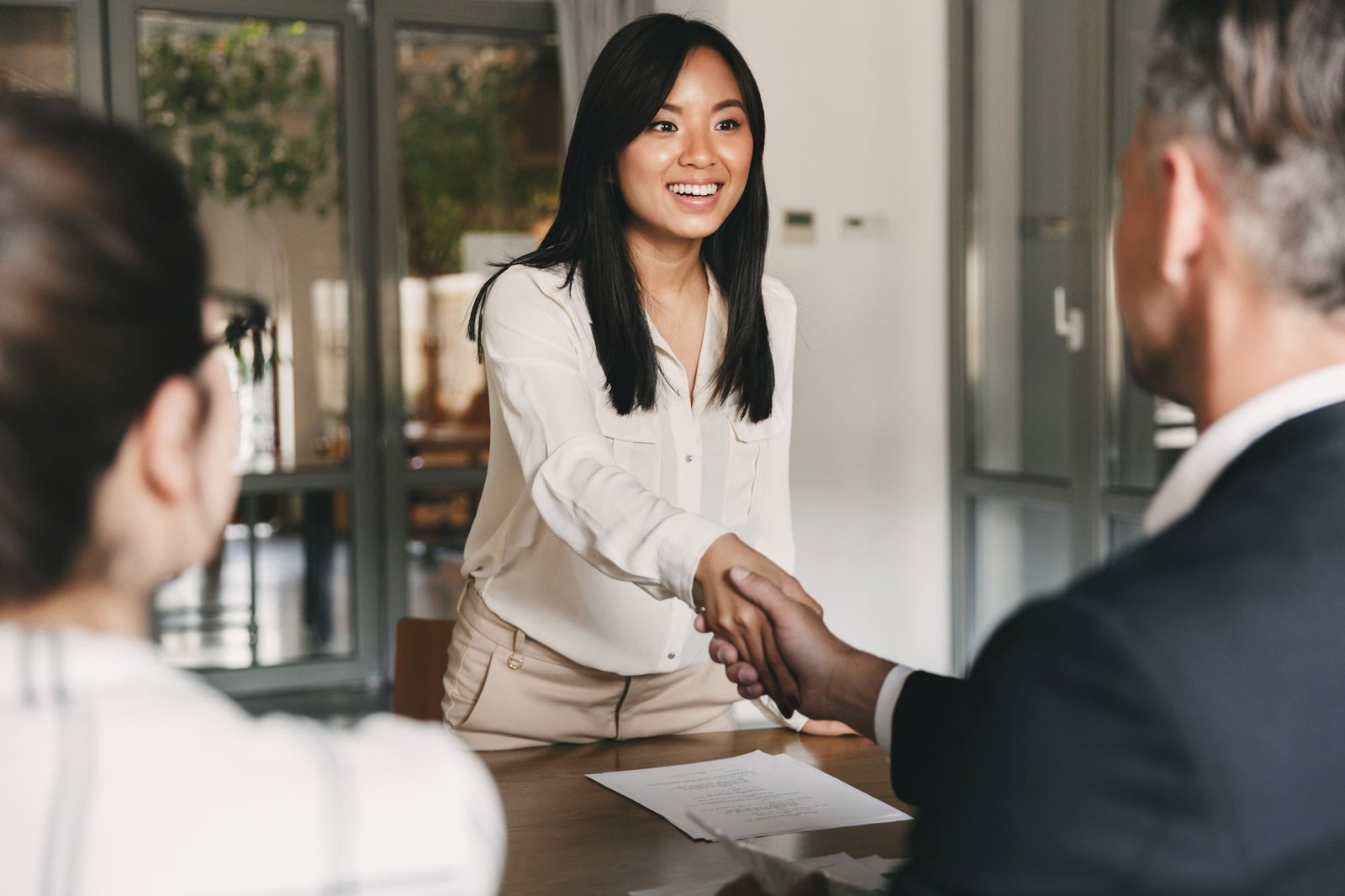 A potential employee shaking hands with a hiring manager