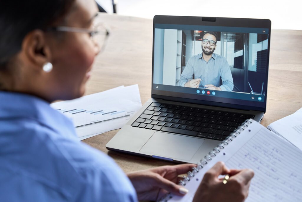 An employee on a video call with their coworker