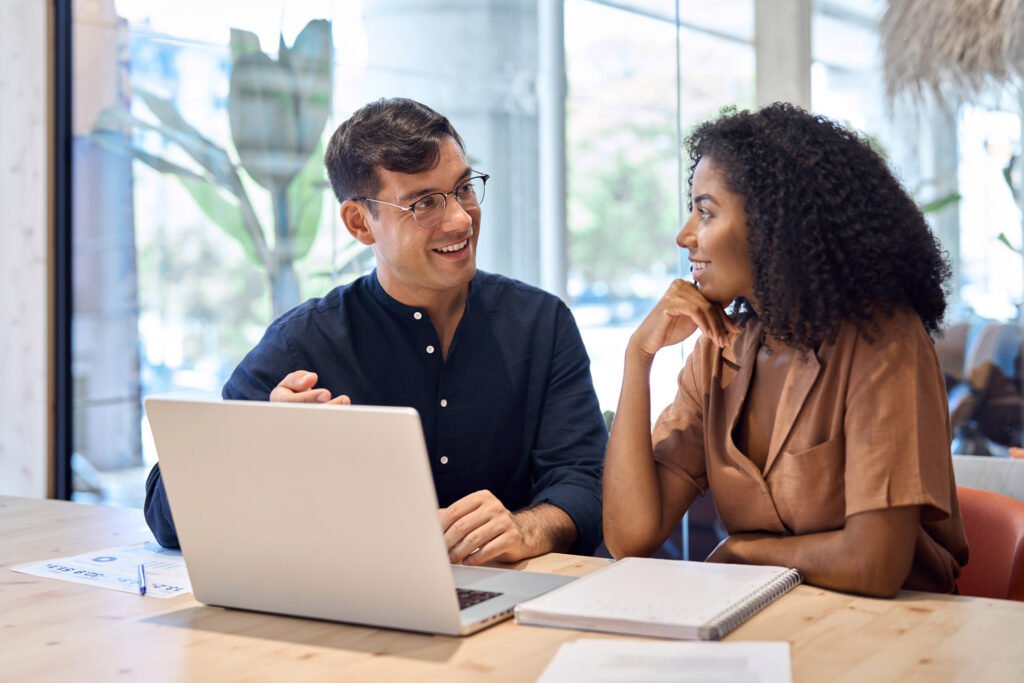 Two coworkers working together on a laptop