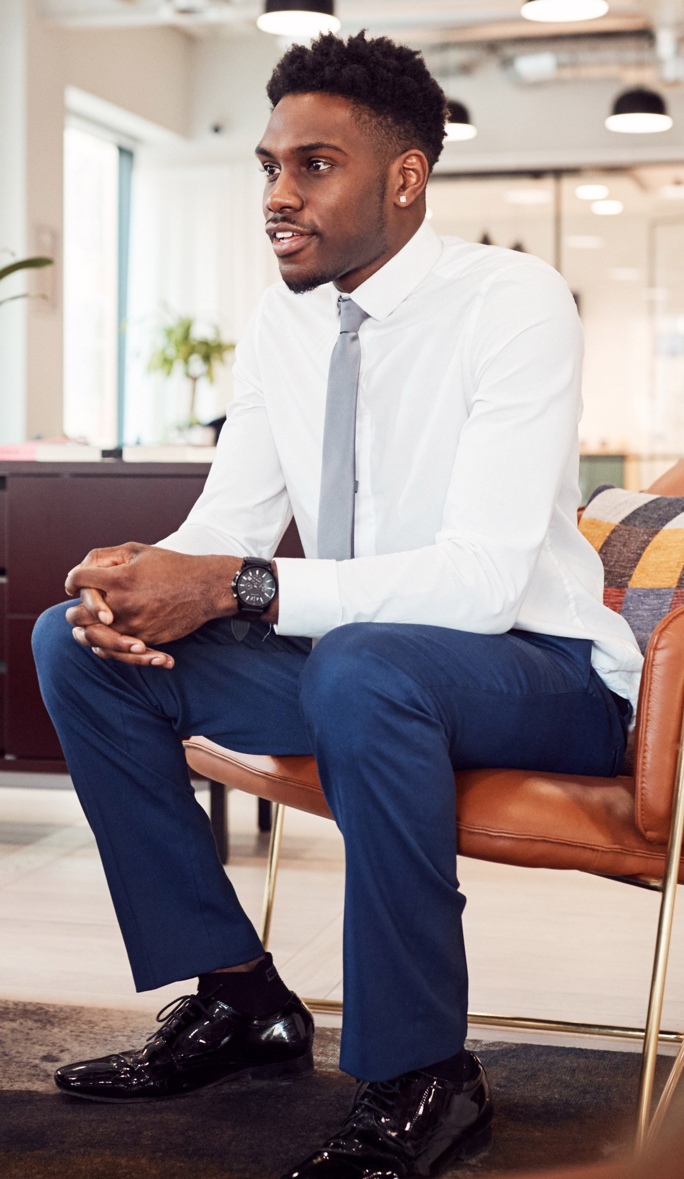 An employee sitting on a lounge chair during a meeting