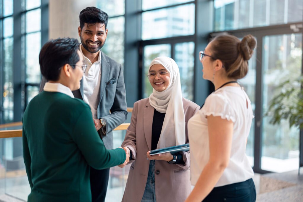 A group of new talent stand chatting in a circle