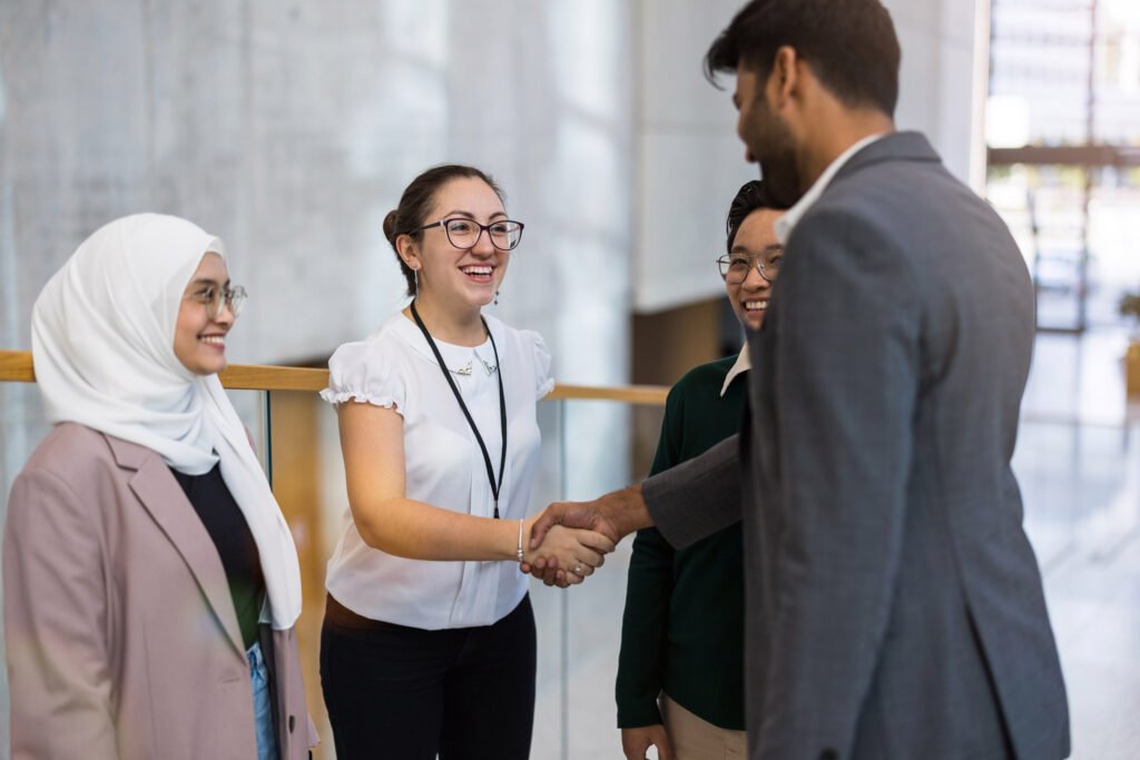 A group of employees shaking hands at a conference