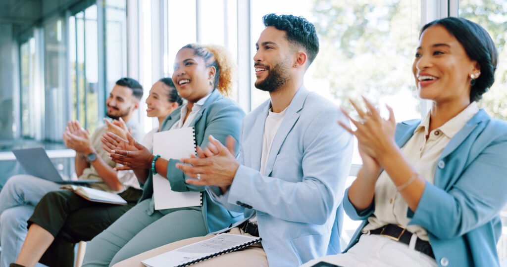 A line of potential employees sitting and clapping