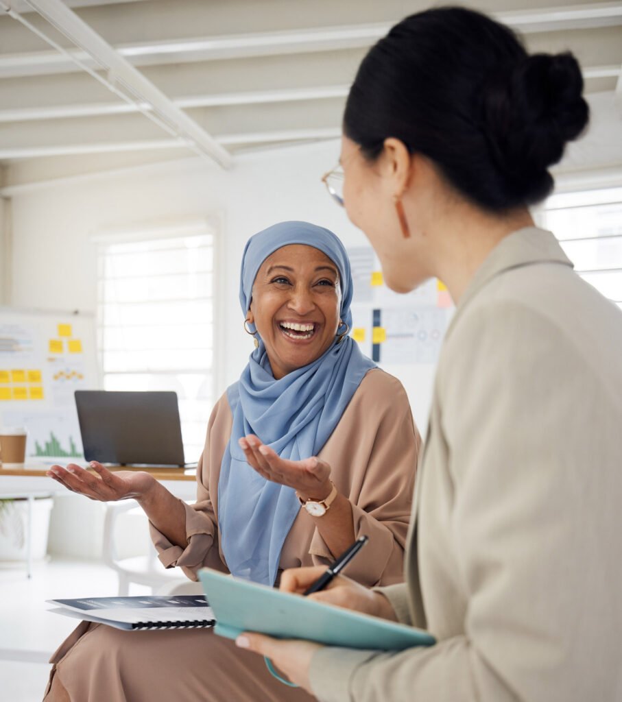 Two employees chatting during a meeting