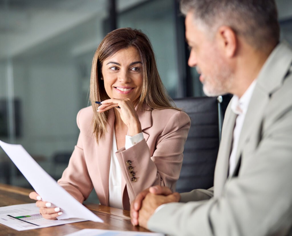 A mentor and mentee sitting discussing business