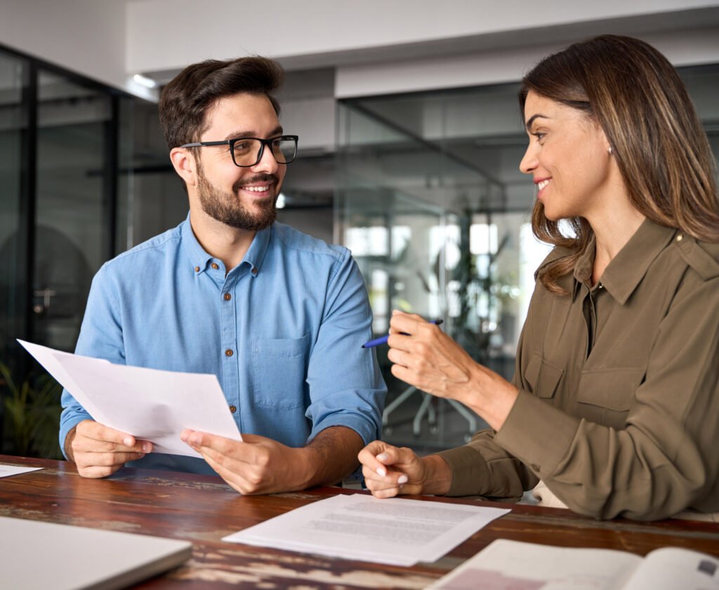 Two coworkers in a meeting discussing hiring