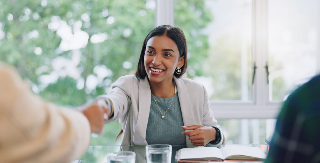 A potential new employee shaking hands at an interview