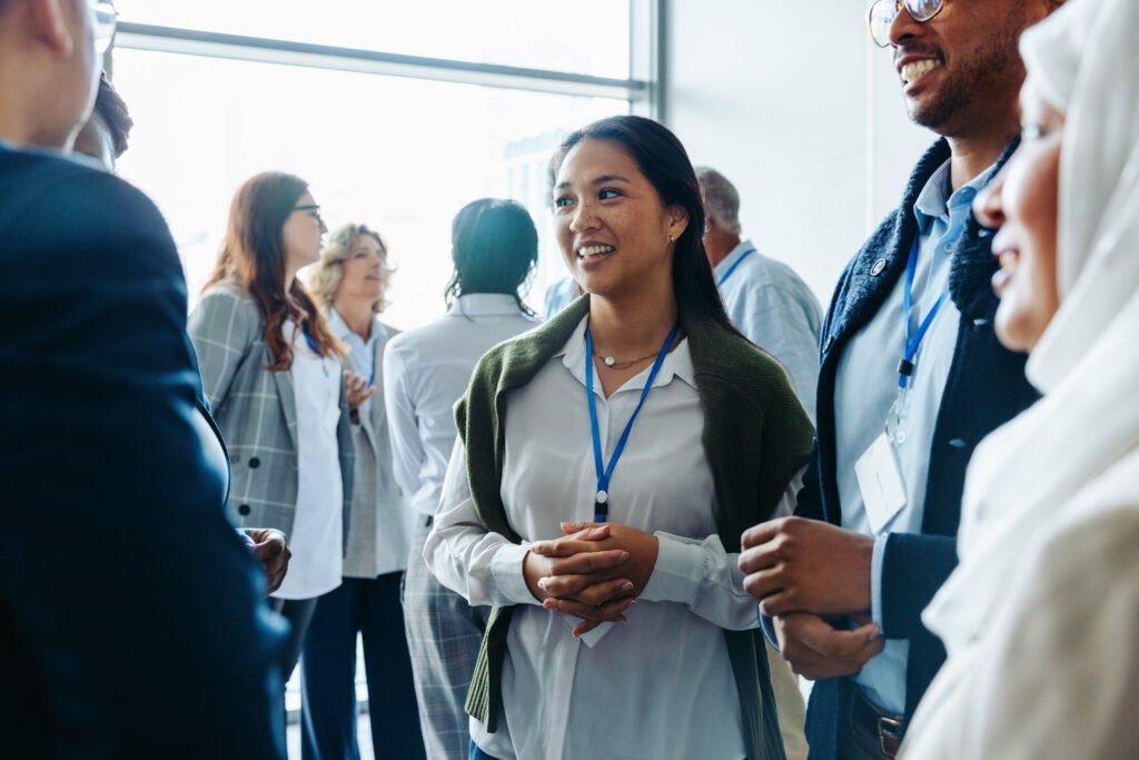 A group of employers standing chatting at a conference