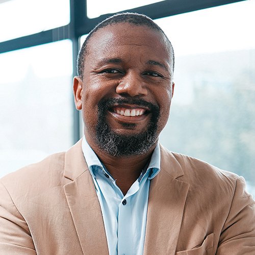 Headshot of a man standing smiling