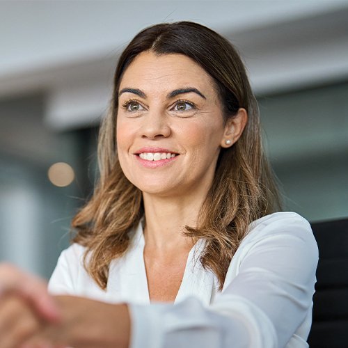 Employer smiling shaking hands with employee
